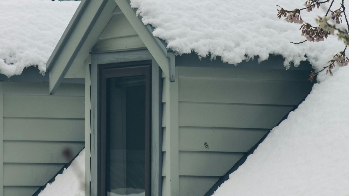Snow-Covered Window and Roof - Roof and Window Repairs in December