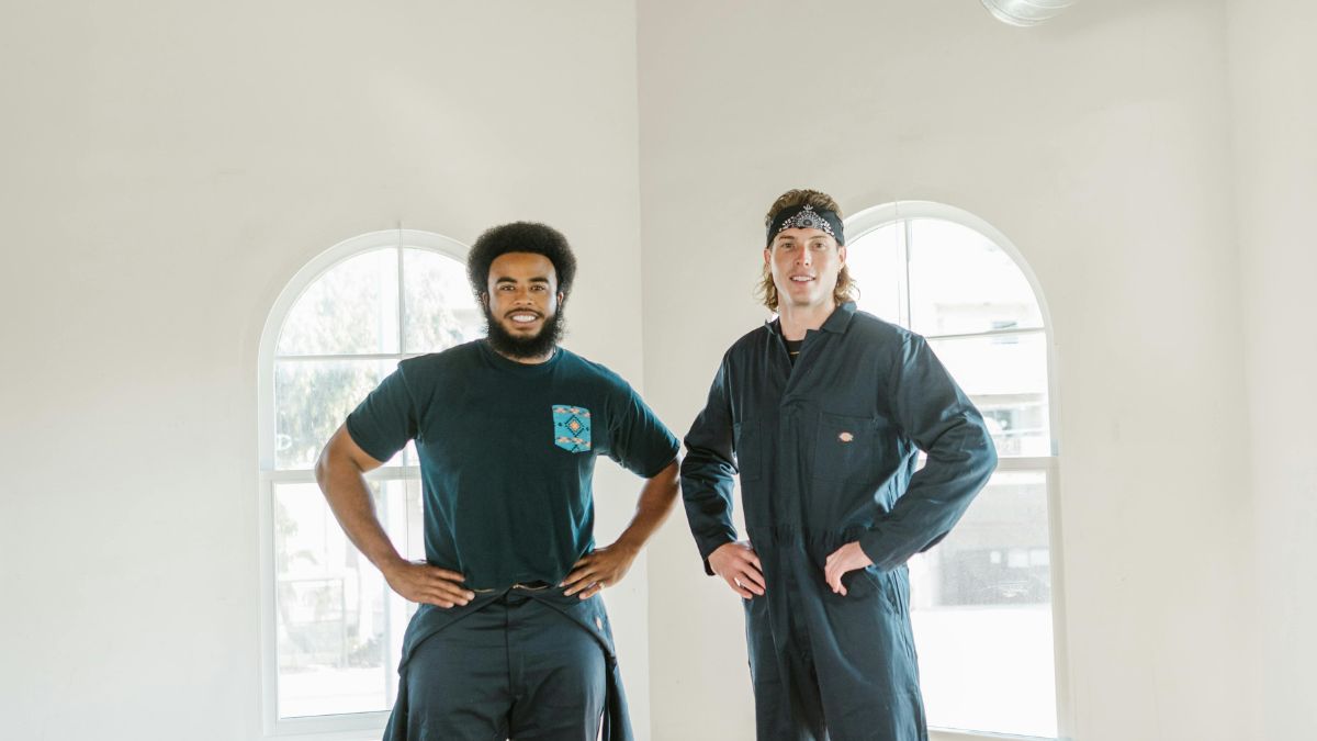 Two Men standing in a Room In front of Windows - Window Replacement and Upgrade Services